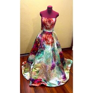This whimsical ball gown has beads, two side pockets & is fully lined.